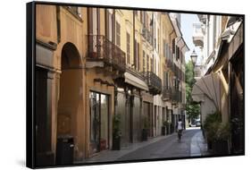 Italy, Lombardy, Cremona, cobblestone street with bicycles and old buildings-Alan Klehr-Framed Stretched Canvas