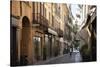 Italy, Lombardy, Cremona, cobblestone street with bicycles and old buildings-Alan Klehr-Stretched Canvas