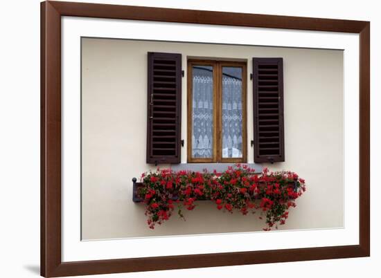 Italy, Radda in Chianti. Flower boxes with red geraniums below a window with shutters.-Julie Eggers-Framed Photographic Print