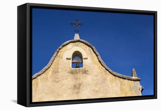 Italy, Sardinia, Gavoi. the Bell and Cross of an Old Church, Backed by a Blue Sky-Alida Latham-Framed Stretched Canvas