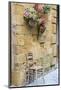 Italy, Tuscany. Chair and flower pots outside the entrance to a shop in a village in Tuscany.-Julie Eggers-Mounted Photographic Print