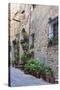 Italy, Tuscany, Crete Senesi, Asciano. Street scene with potted flowers-Julie Eggers-Stretched Canvas