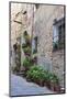 Italy, Tuscany, Crete Senesi, Asciano. Street scene with potted flowers-Julie Eggers-Mounted Photographic Print