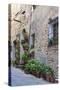 Italy, Tuscany, Crete Senesi, Asciano. Street scene with potted flowers-Julie Eggers-Stretched Canvas