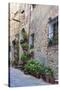 Italy, Tuscany, Crete Senesi, Asciano. Street scene with potted flowers-Julie Eggers-Stretched Canvas