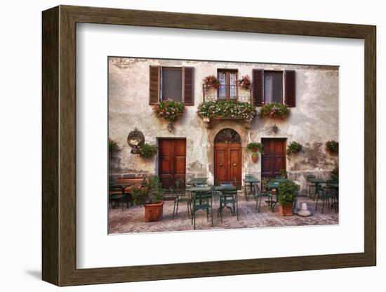 Italy, Tuscany, Pienza. Tables and chairs set up outside for outdoor dining in the town of Pienza.-Julie Eggers-Framed Photographic Print