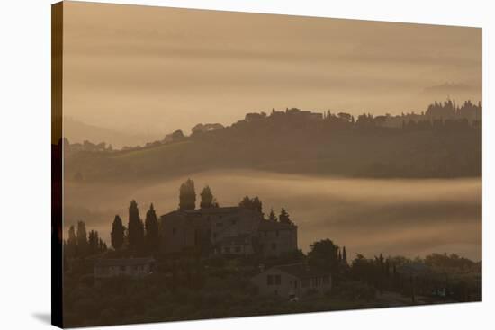 Italy, Tuscany, San Gimignano, farmhouses on ridges with fog at dawn.-Merrill Images-Stretched Canvas