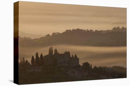 Italy, Tuscany, San Gimignano, farmhouses on ridges with fog at dawn.-Merrill Images-Stretched Canvas