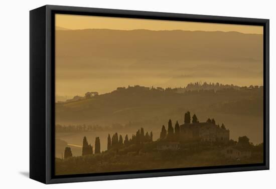 Italy, Tuscany, San Gimignano, farmhouses on ridges with fog at dawn.-Merrill Images-Framed Stretched Canvas