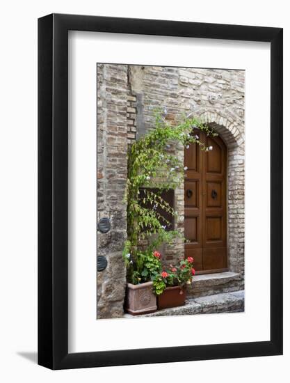 Italy, Tuscany, San Gimignano. Homes decorated with flower pots along the streets of San Gimignano.-Julie Eggers-Framed Photographic Print