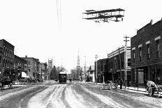 Biplane over a Small Town-J.H. Cave-Photographic Print