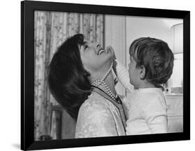 Jackie Kennedy Laughs as Her Son John Jr, Plays with Her Pearl Necklace, Nov.1962-null-Framed Photo