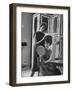 Jackie Kennedy Style Pillbox Hats Being Tried on by Models at Charles A. Stevens and Co-Francis Miller-Framed Photographic Print