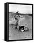 Jackie Kennedy, Wife of Sen, Walking Along Beach with Her Slicker Clad Daughter Caroline-Alfred Eisenstaedt-Framed Stretched Canvas