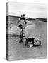 Jackie Kennedy, Wife of Sen, Walking Along Beach with Her Slicker Clad Daughter Caroline-Alfred Eisenstaedt-Stretched Canvas