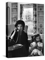 Jackie Kennedy, Wife of Senator John Kennedy, Talking on the Telephone as her daughter mimics her-Alfred Eisenstaedt-Stretched Canvas