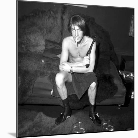 Jacques Dutronc Smoking a Cigarette and Holding a Revolver in 1971-Roldes-Mounted Photographic Print