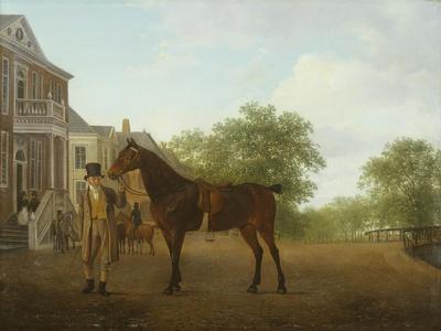 A Gentleman Holding a Saddled Horse in a Street by a Canal