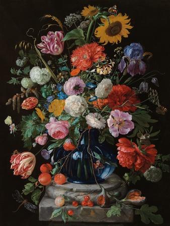 Tulips, a sunflower, an iris and numerous other flowers in a glass vase on marble column base