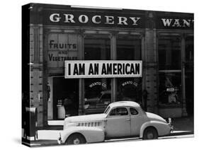 Japanese American shop owner in Oakland, CA hopes to avoid internment after Pearl Harbor, 1942-Dorothea Lange-Stretched Canvas