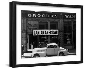 Japanese American shop owner in Oakland, CA hopes to avoid internment after Pearl Harbor, 1942-Dorothea Lange-Framed Photographic Print