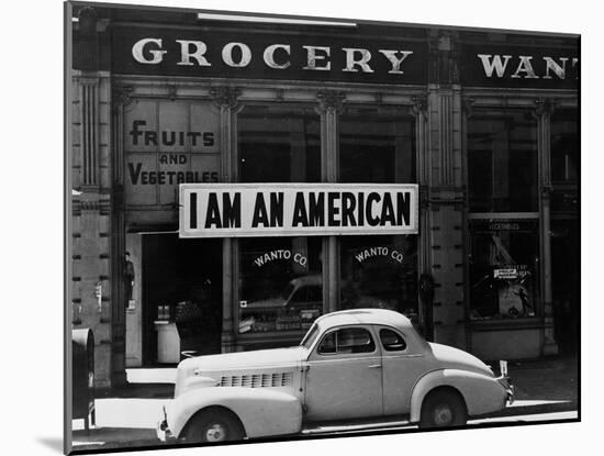 Japanese American shop owner in Oakland, CA hopes to avoid internment after Pearl Harbor, 1942-Dorothea Lange-Mounted Photographic Print