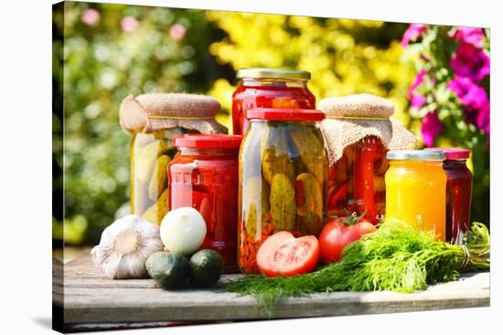 Jars Of Pickled Vegetables In The Garden. Marinated Food-monticello-Stretched Canvas