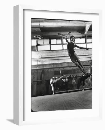 Jean Babilee, Star of Ballets Des Champs Elysees, Leaping During Practice as Other Dancers Watch-Gjon Mili-Framed Photographic Print