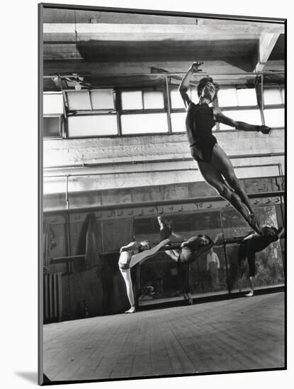 Jean Babilee, Star of Ballets Des Champs Elysees, Leaping During Practice as Other Dancers Watch-Gjon Mili-Mounted Photographic Print