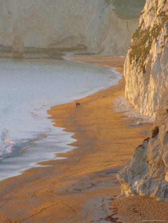 Couple Walking on Beach. Isle of Purbeck, Dorset, England UK