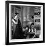 Jean Cocteau Sketching Model Elizabeth Gibbons in a Chanel Dress in His Hotel Bedroom-Roger Schall-Framed Premium Photographic Print