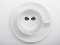 A Coffee Cup with Two Coffee Beans Making a Smiley Face-Jean Gillis-Framed Stretched Canvas