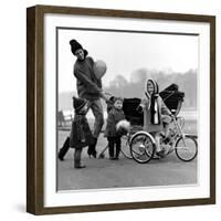 Jenny Boyd in Light Pants and Boots with Children, 1960s-John French-Framed Giclee Print