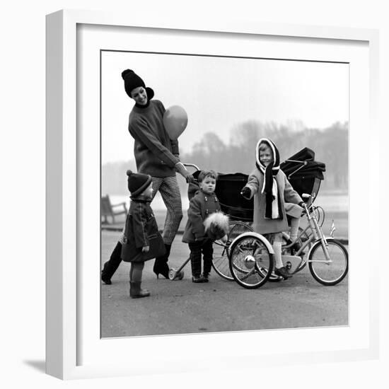 Jenny Boyd in Light Pants and Boots with Children, 1960s-John French-Framed Giclee Print