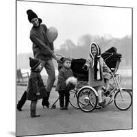 Jenny Boyd in Light Pants and Boots with Children, 1960s-John French-Mounted Giclee Print