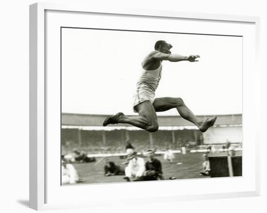 Jesse Owens in Action at the Long Jump During the Berlin Olympics, 1936-null-Framed Photographic Print