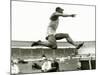 Jesse Owens in Action at the Long Jump During the Berlin Olympics, 1936-null-Mounted Photographic Print