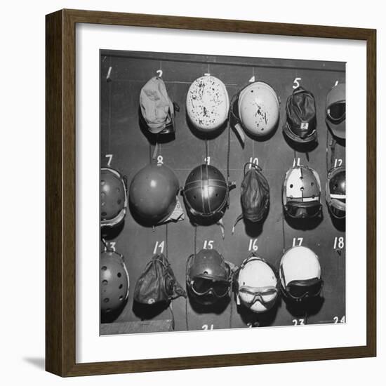 Jet Pilot Helmets and Goggles Hanging on Hooks-Charles E^ Steinheimer-Framed Photographic Print