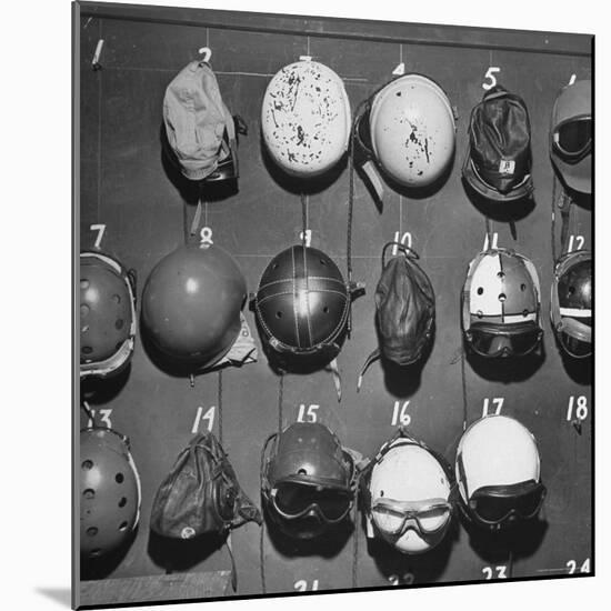 Jet Pilot Helmets and Goggles Hanging on Hooks-Charles E^ Steinheimer-Mounted Photographic Print