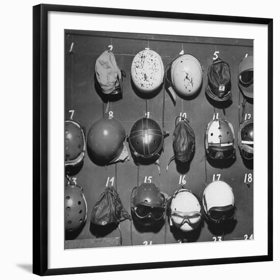 Jet Pilot Helmets and Goggles Hanging on Hooks-Charles E^ Steinheimer-Framed Photographic Print