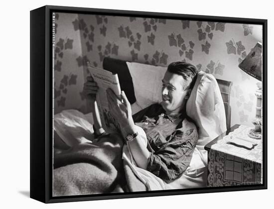 Jimmy Stewart, Dressed in Silk Pajamas Reading Magazine in Bed in Family Home-Peter Stackpole-Framed Stretched Canvas