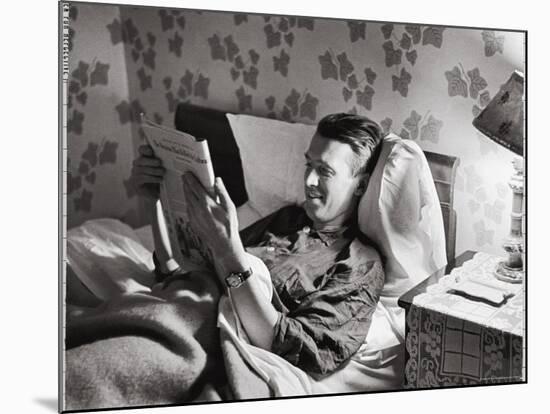 Jimmy Stewart, Dressed in Silk Pajamas Reading Magazine in Bed in Family Home-Peter Stackpole-Mounted Premium Photographic Print