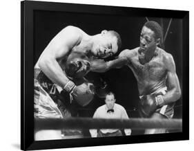 Joe Louis (Left), and Ezzard Charles, in a Heavyweight Title Bout, Sept. 27, 1950-null-Framed Photo