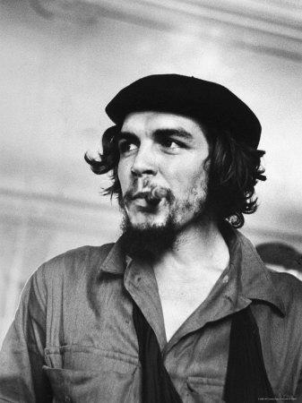 Cuban Rebel Ernesto "Che" Guevara with Lit Cigar Clenched Between Teeth and Left Arm in a Sling