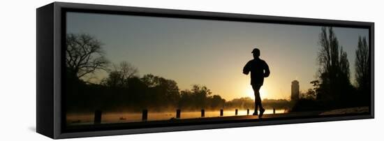 Jogger Silhouetted Against the Rising Sun as He Runs Past the Serpentine Lake in Hyde Park, London-null-Framed Stretched Canvas