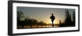 Jogger Silhouetted Against the Rising Sun as He Runs Past the Serpentine Lake in Hyde Park, London-null-Framed Premium Photographic Print