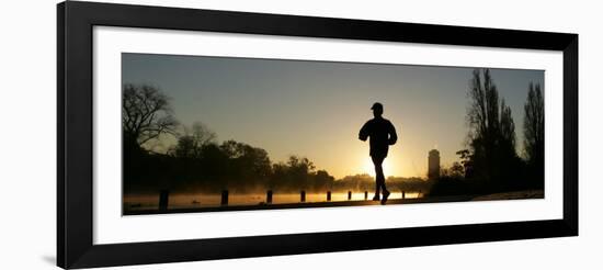 Jogger Silhouetted Against the Rising Sun as He Runs Past the Serpentine Lake in Hyde Park, London-null-Framed Photographic Print