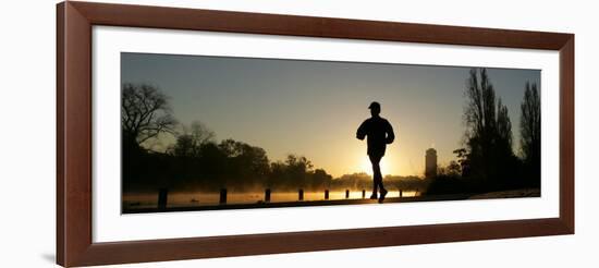 Jogger Silhouetted Against the Rising Sun as He Runs Past the Serpentine Lake in Hyde Park, London-null-Framed Photographic Print