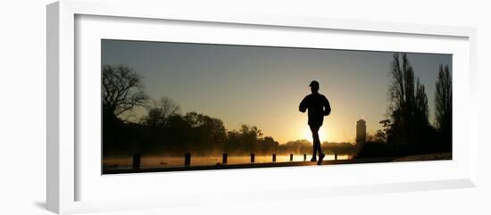 Jogger Silhouetted Against the Rising Sun as He Runs Past the Serpentine Lake in Hyde Park, London-null-Framed Photographic Print