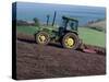 John Deere Tractor with a Rotivator on a Sloping Field in Spring, at Holcombe, Devon, England, UK-Ian Griffiths-Stretched Canvas